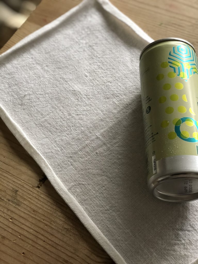 piece of linen and g&t tin