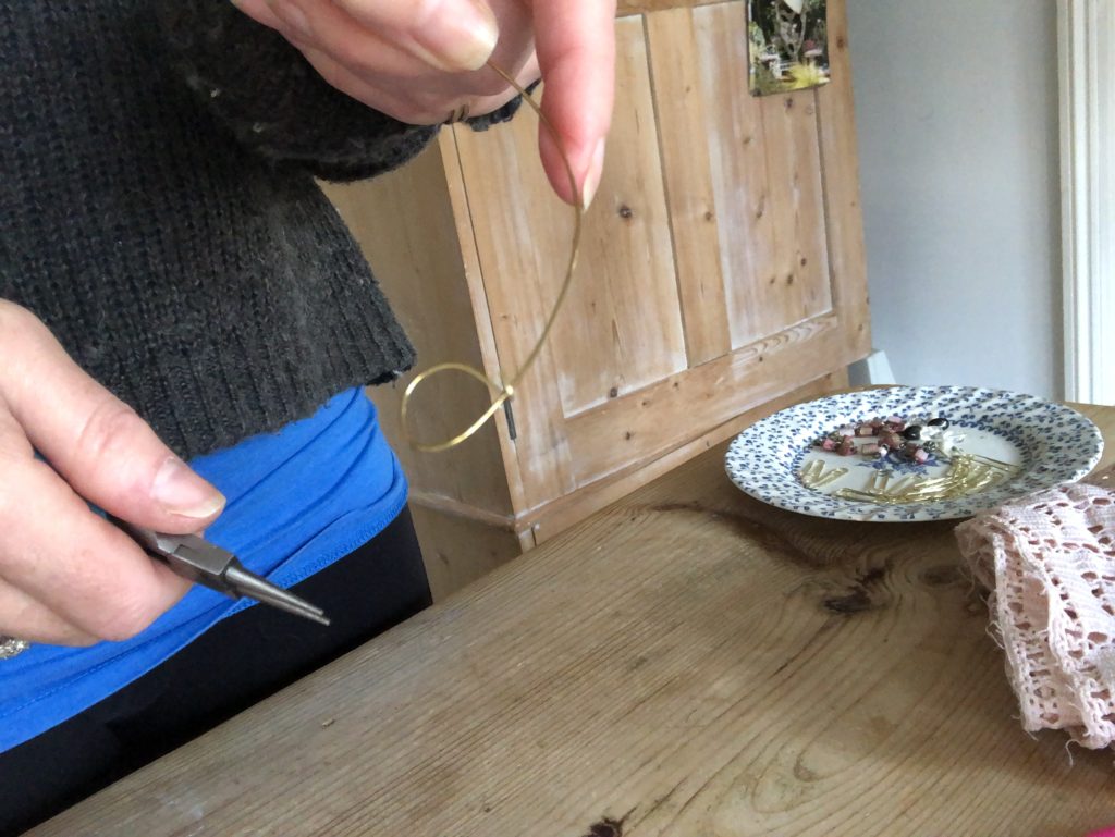 females hands show how to craft a wire halo for fairy peg doll