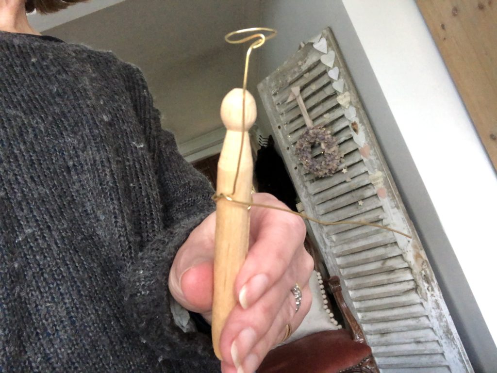 females hands show how to craft a wire halo for fairy peg doll