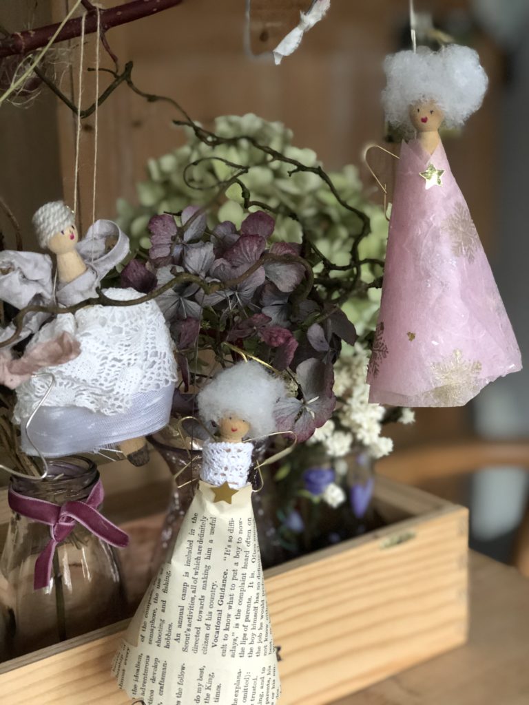 three christmas peg doll fairies hanging in  dried hydrangeas