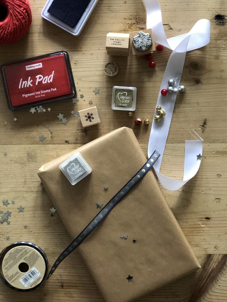 ink pads and stamps decorating brown paper gift wrapping