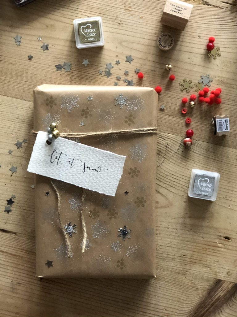 brown paper parcel with string, bells and personalised tag