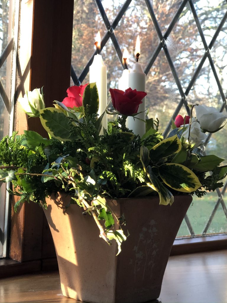 floral and candle display in terracotta pot