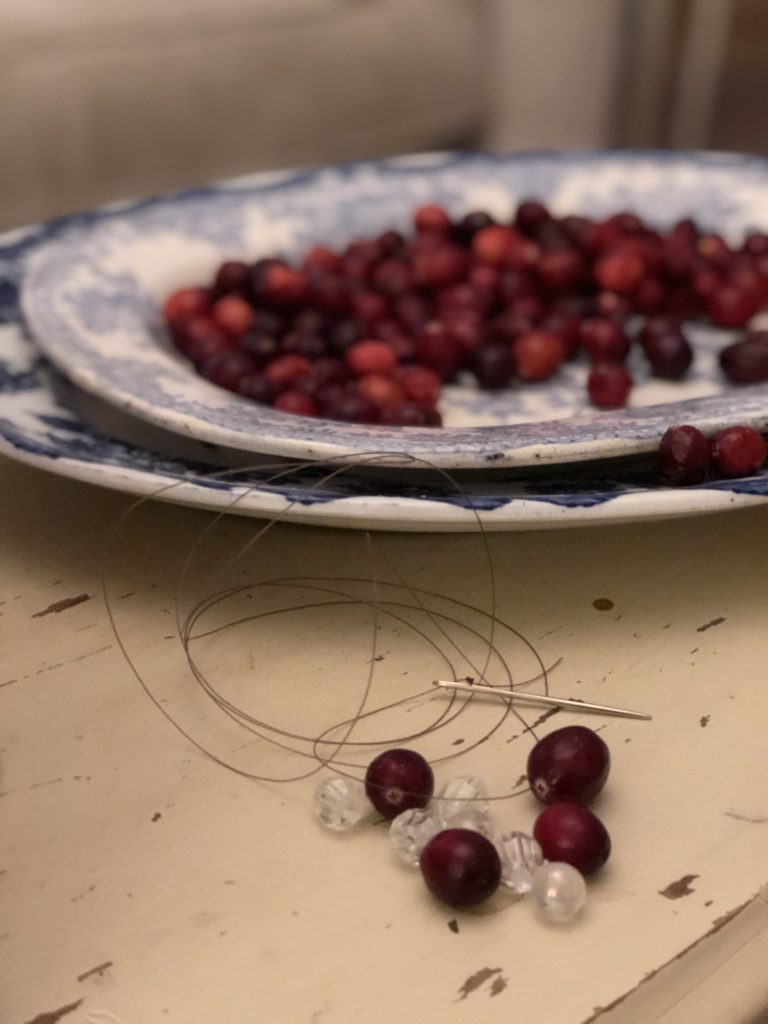 cranberries being made into homemade rustic decorations