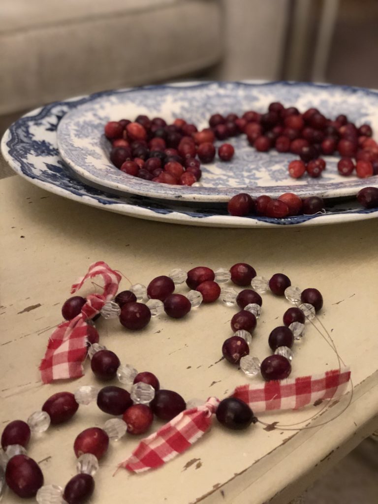 cranberries being made into homemade rustic decorations