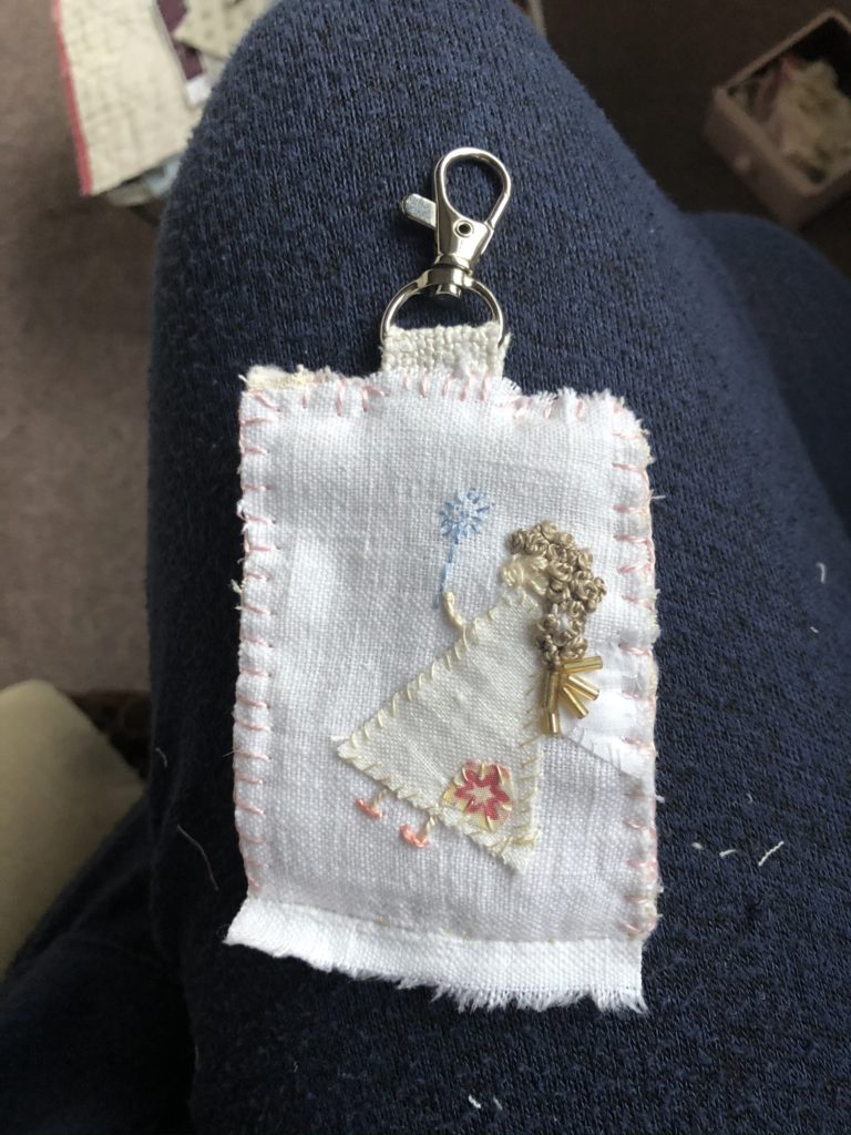 embroidered fabric key ring with angel embellishment