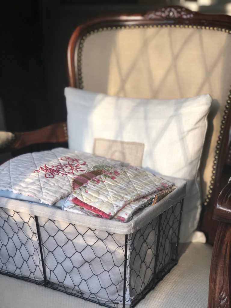 basket of fabric on chair with sunlight