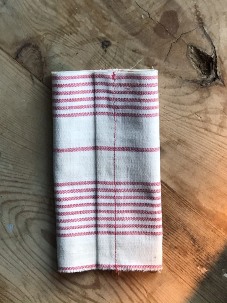 showing how to fold a tissue holder before stitching