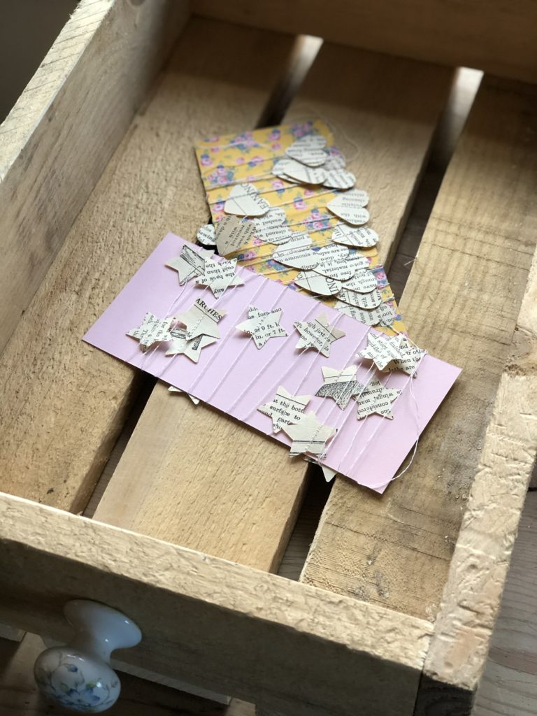 heart and star garland in wooden storage crate