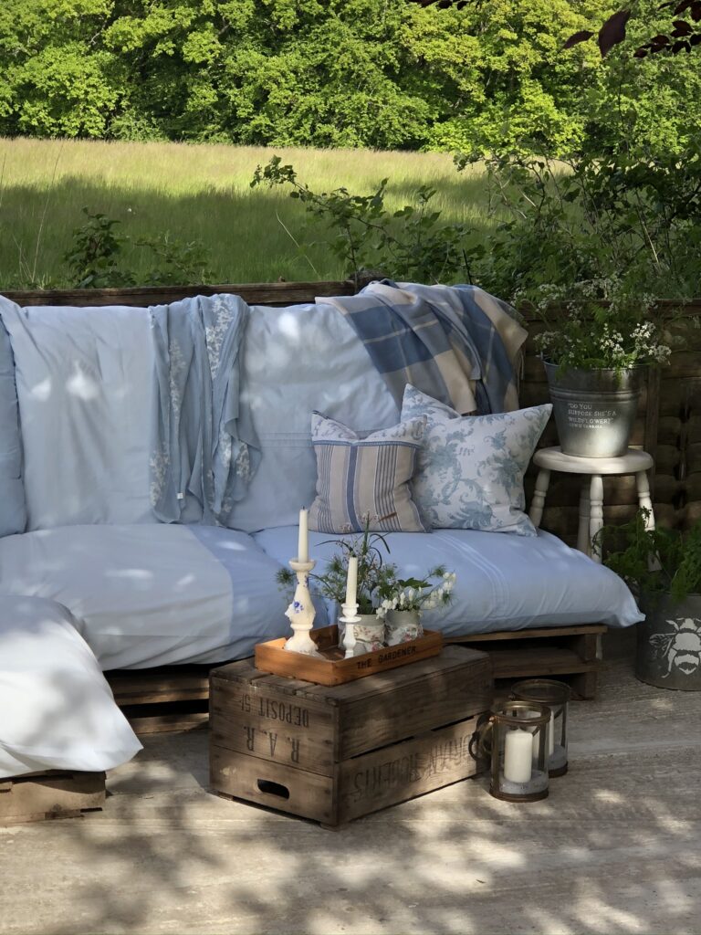 vintage blue pallet sofa cushion covers in garden setting