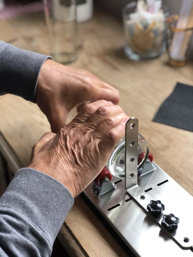 using a glass cutter to cut glass bottles