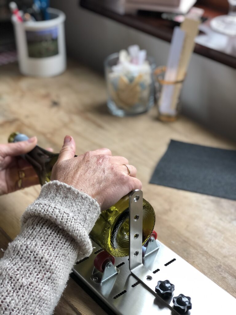 cutting a wine bottle with equipment