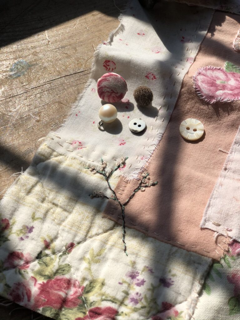 vintage fabrics and buttons make a slow stitching panel