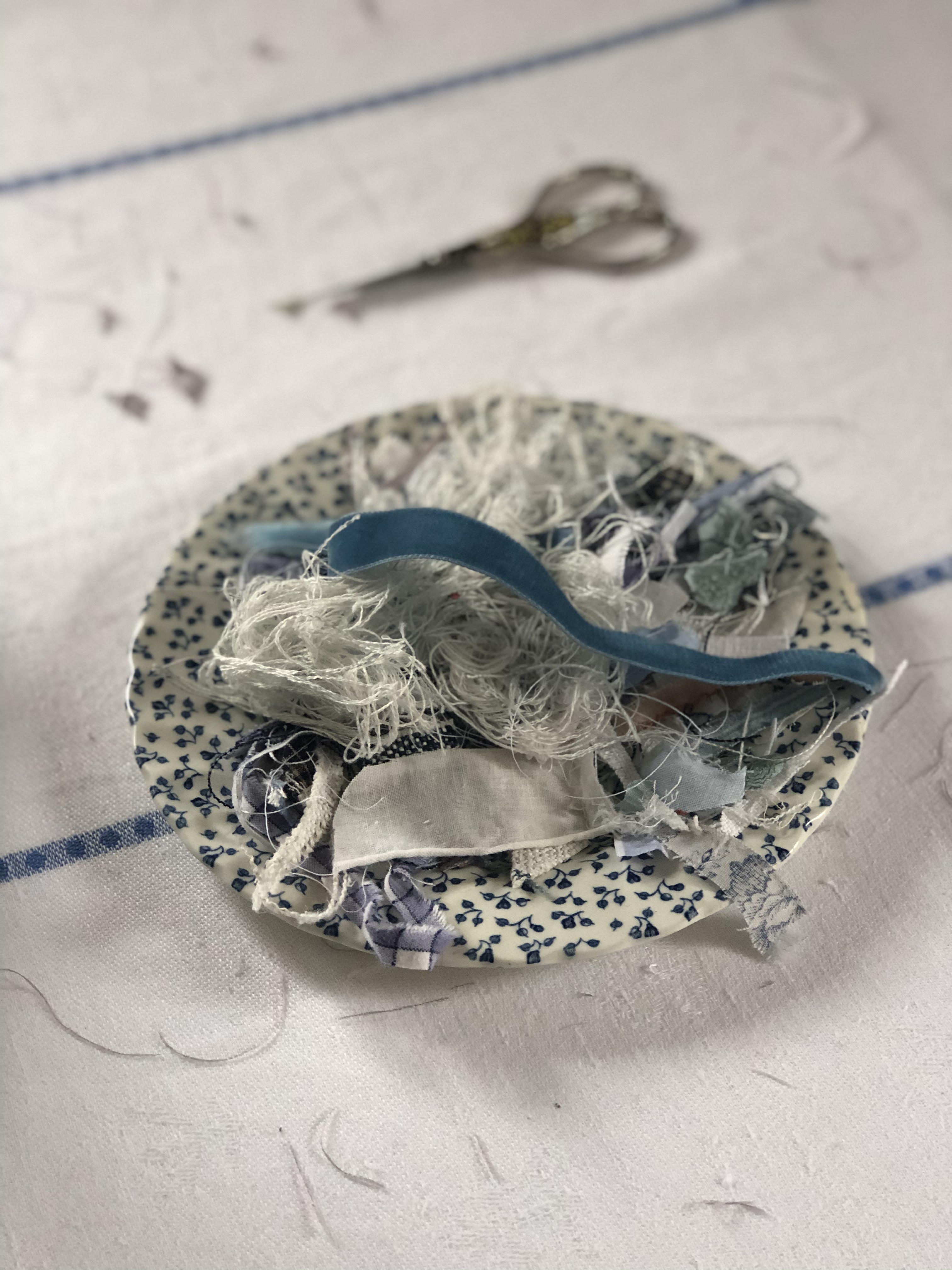 scrap fabric on blue teaplate