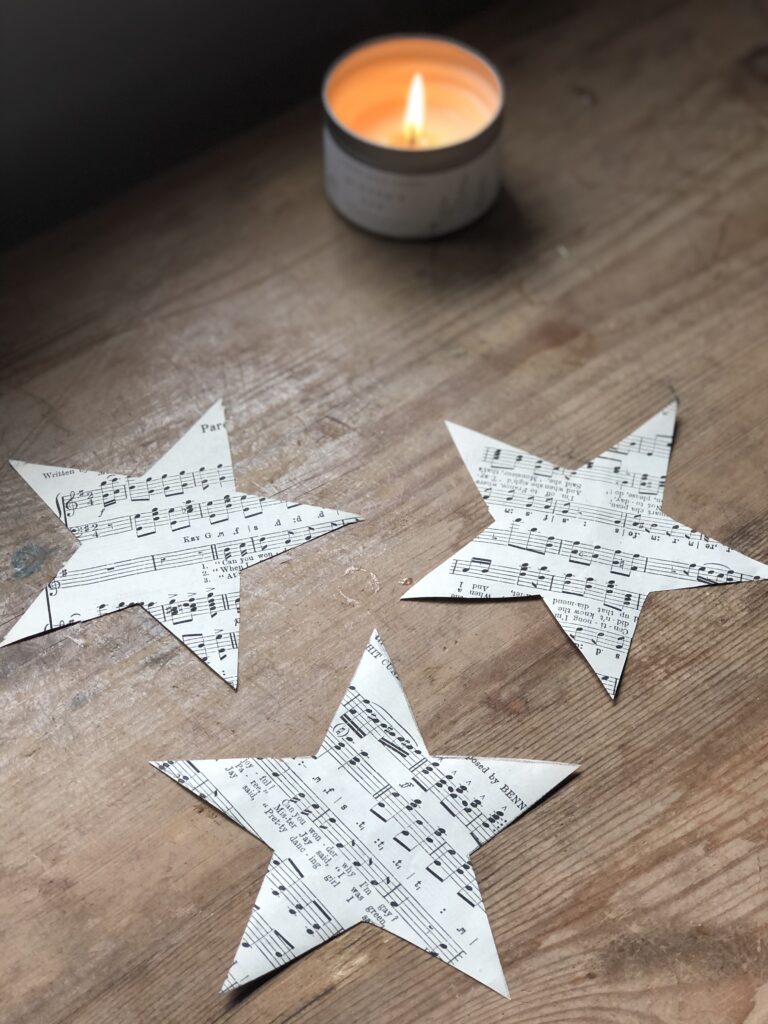 3 music sheet paper stars and candle