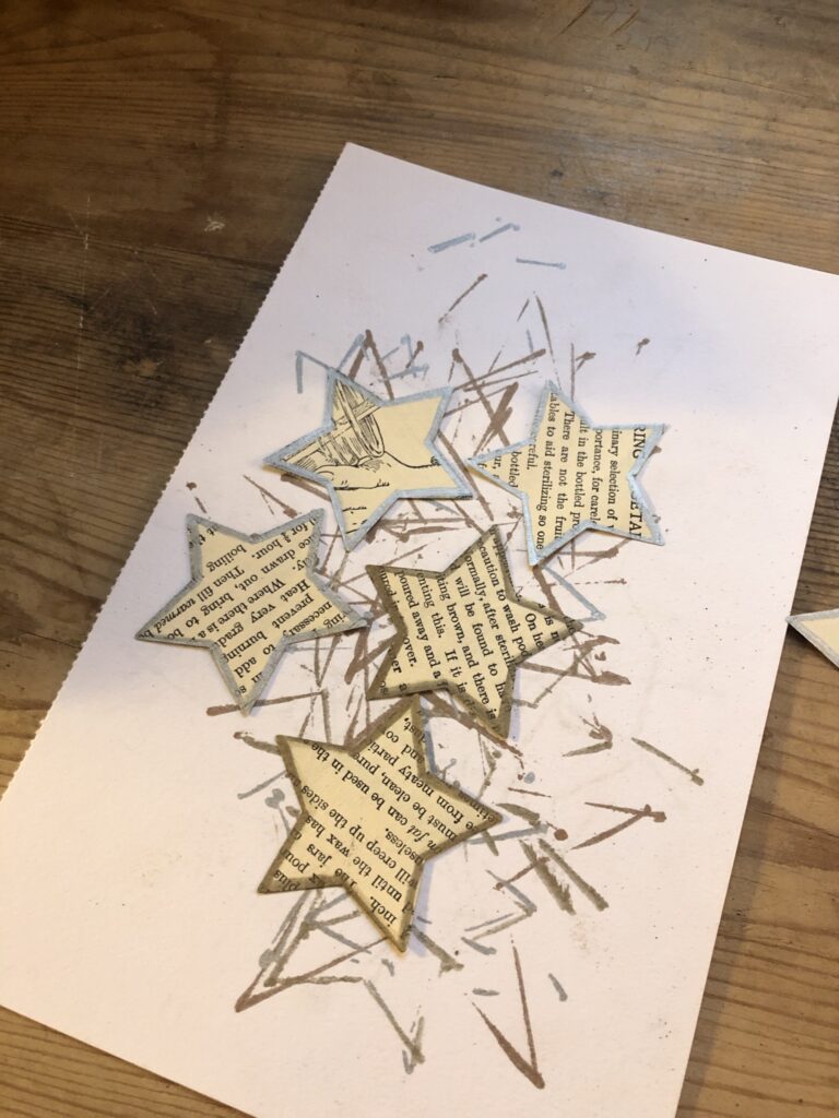 several paper stars with gold and silver edges