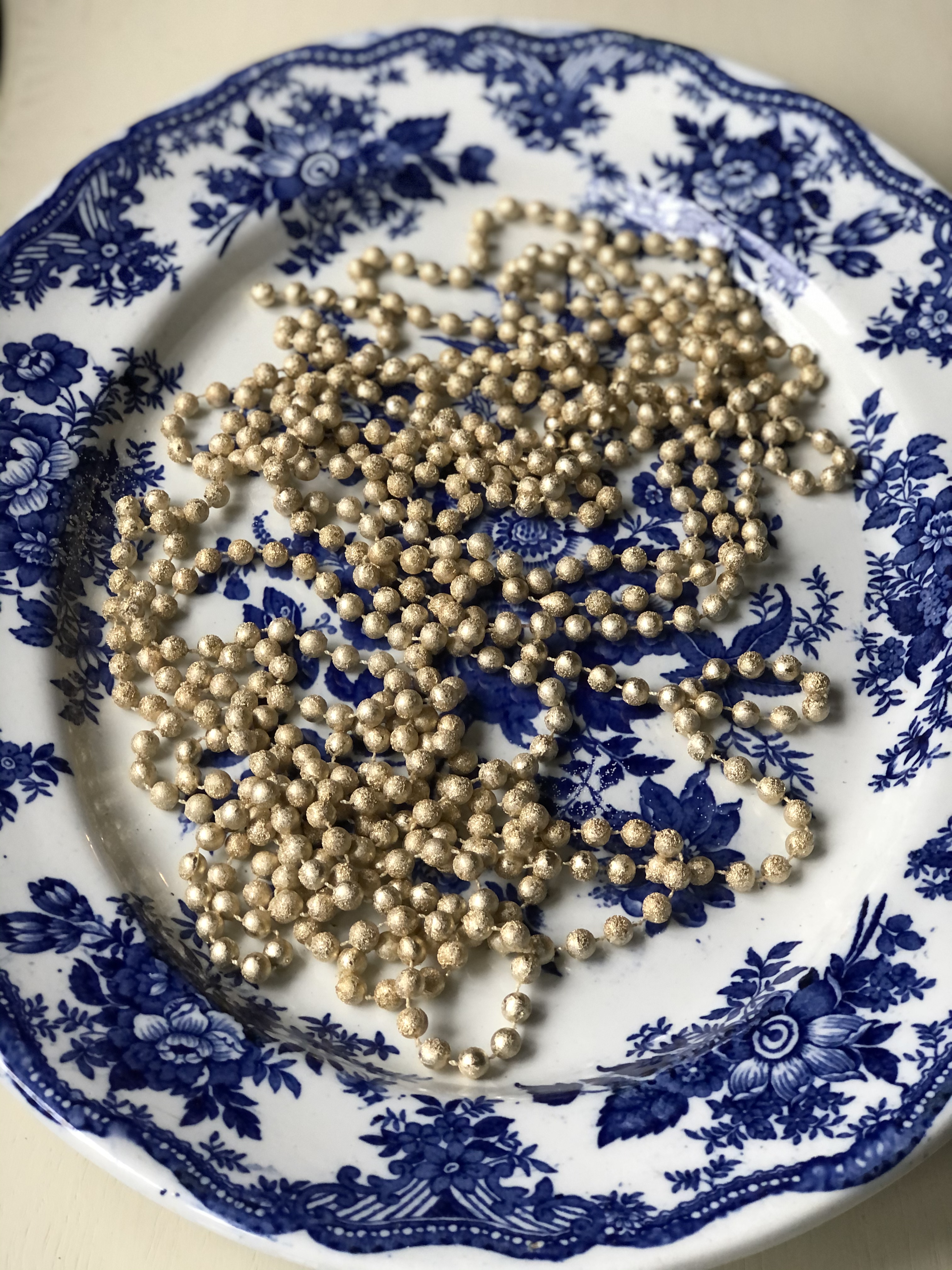 blue and white platter with gold beads