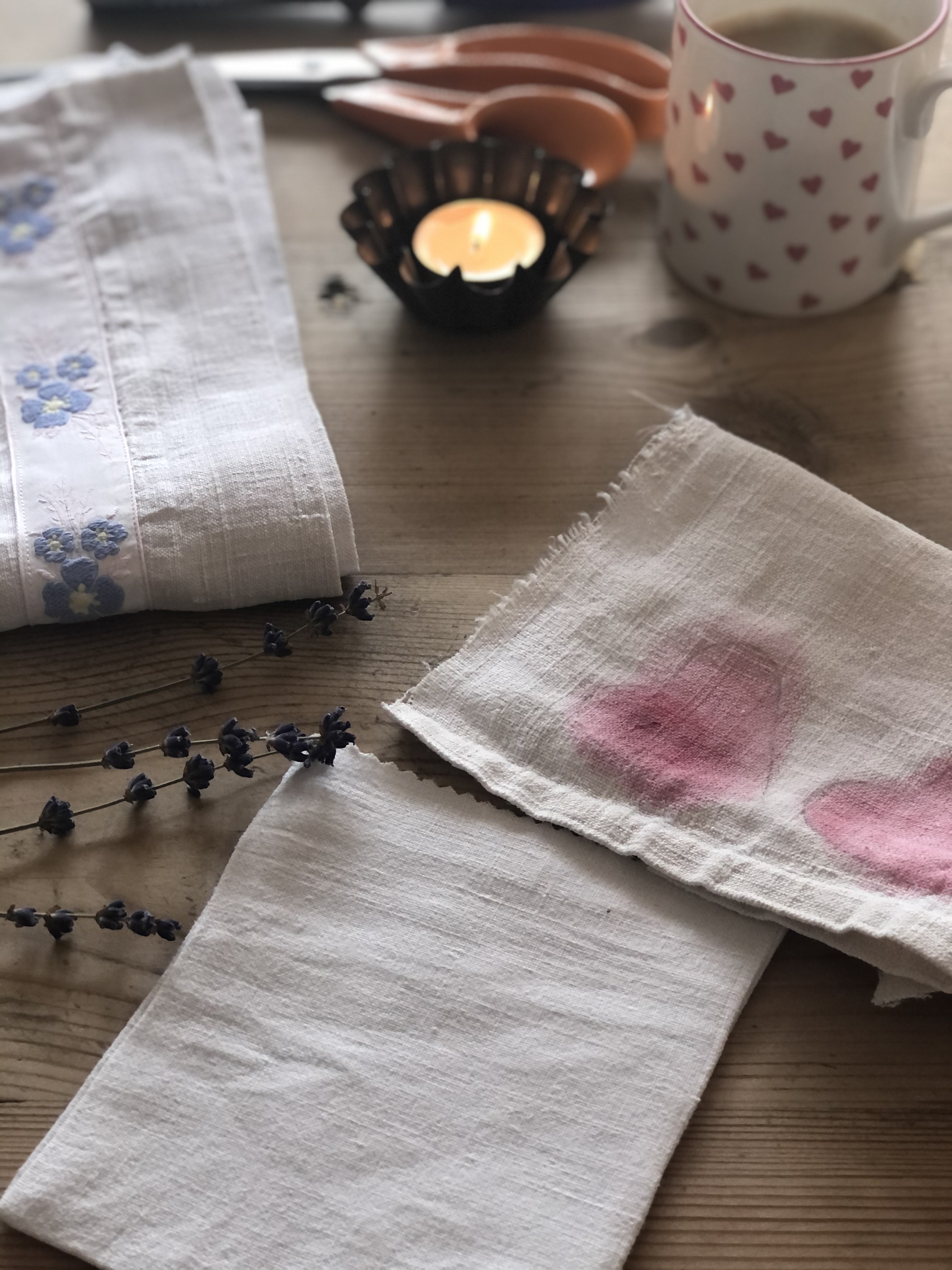 pink watercoloured heart on linen fabric with candle 