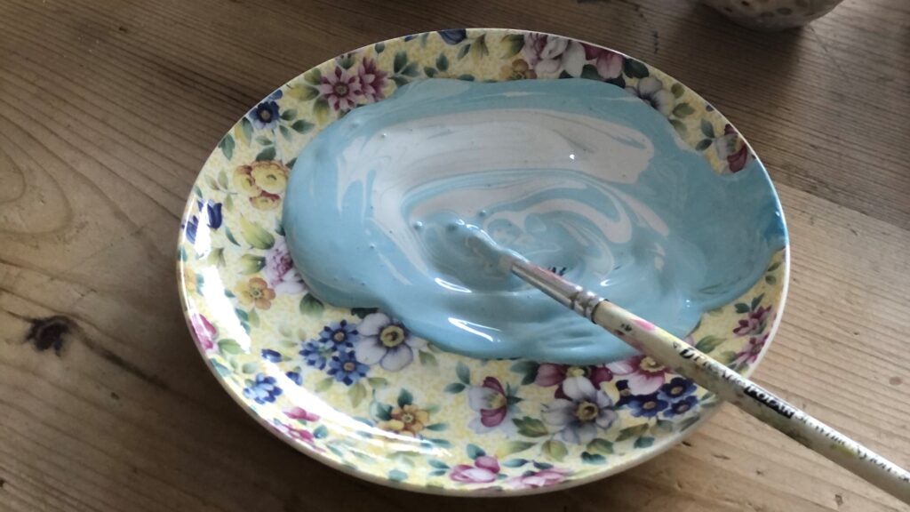 pastel blue paint in vintage saucer