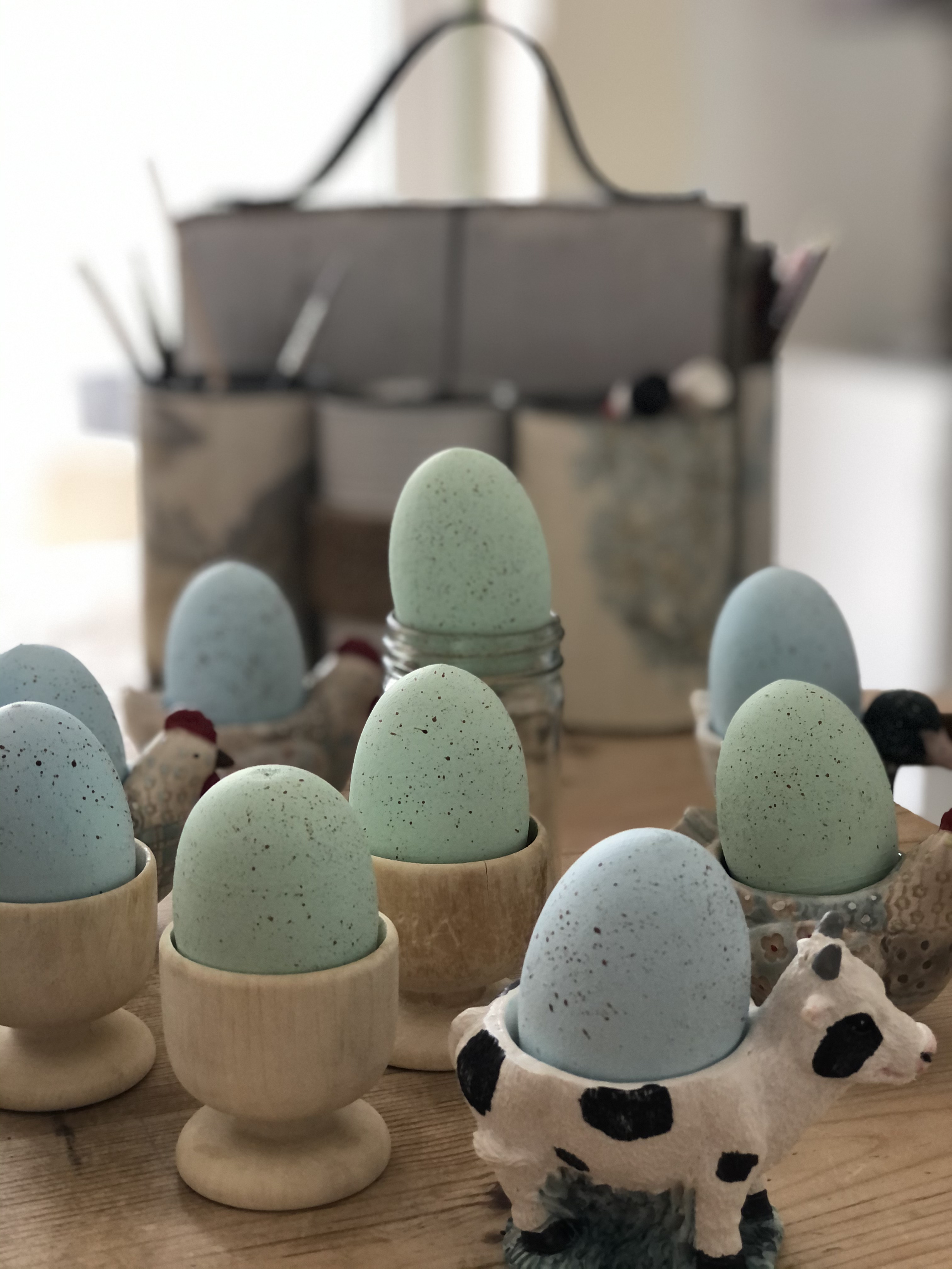 painted wooden eggs in variety of egg cups onfor homemade easter table centrepiece