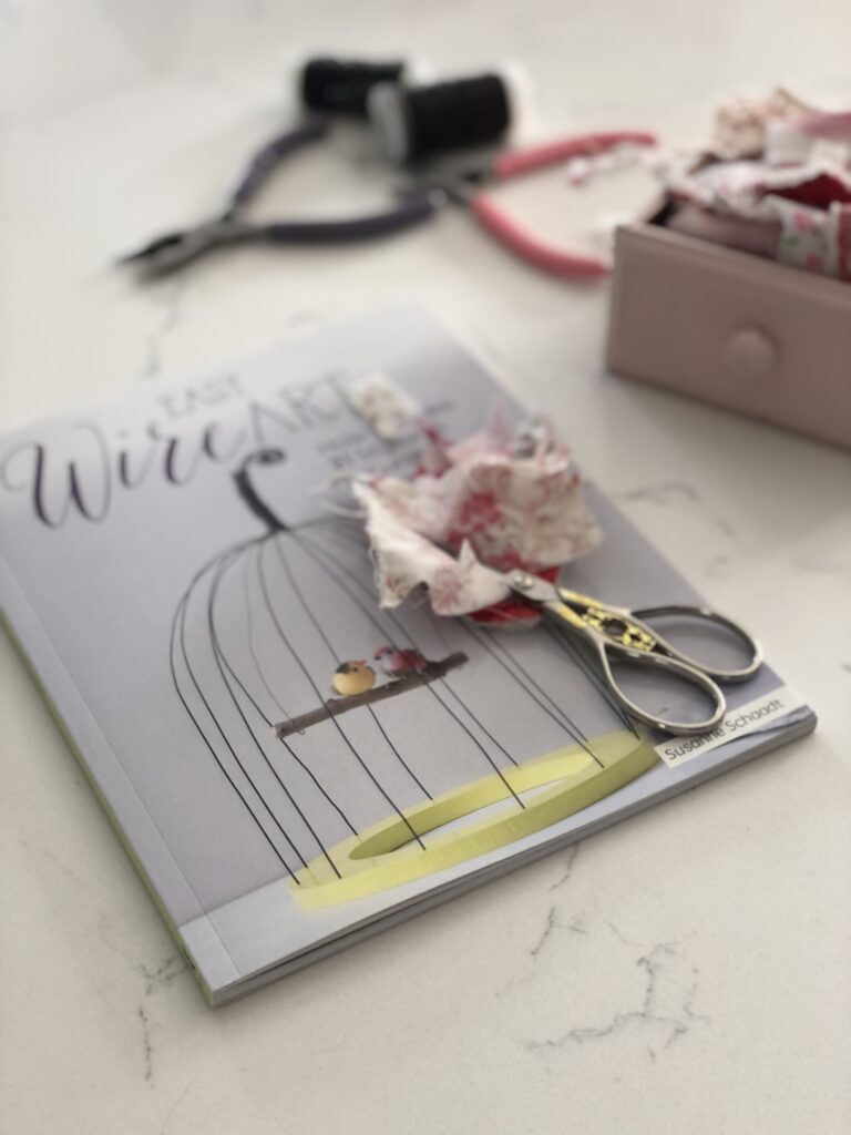 Wire art book scissors and scrap fabric