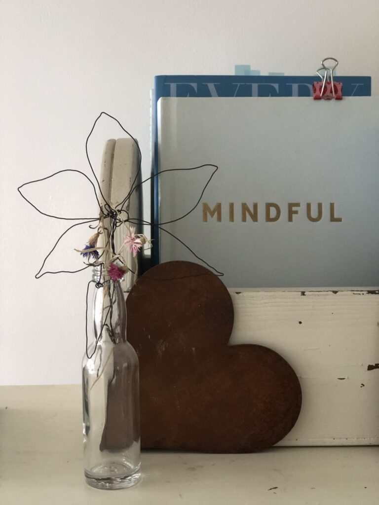 wire craft flower with books and rusty heart