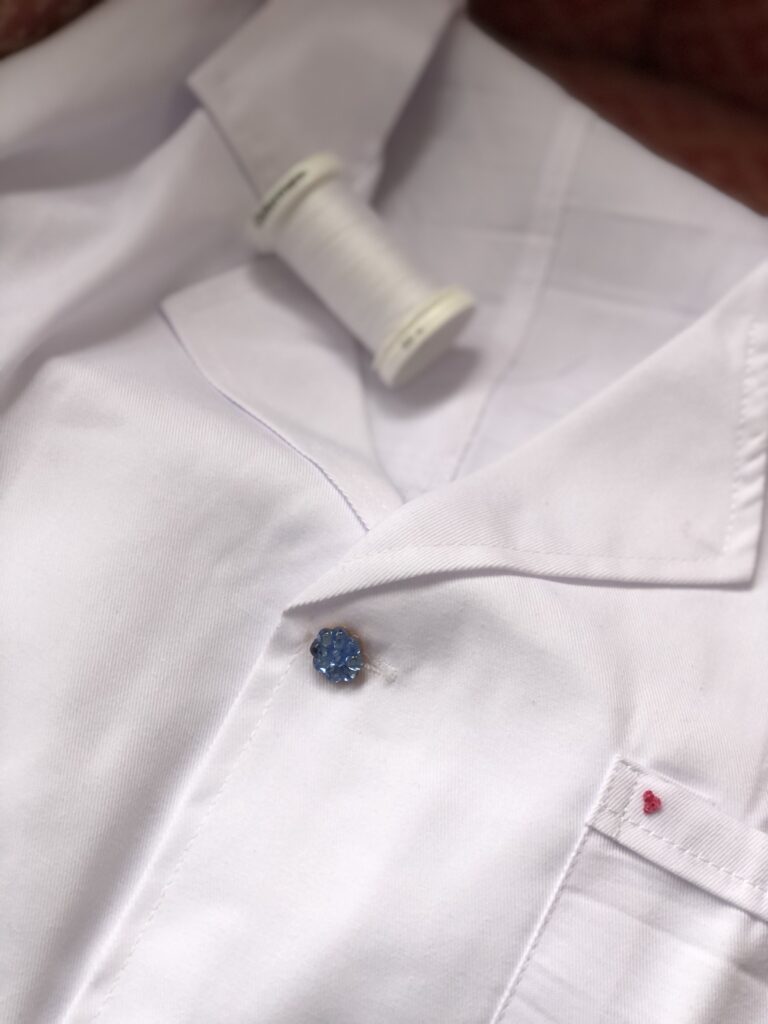 white cotton, blue glass button on white art coveralls