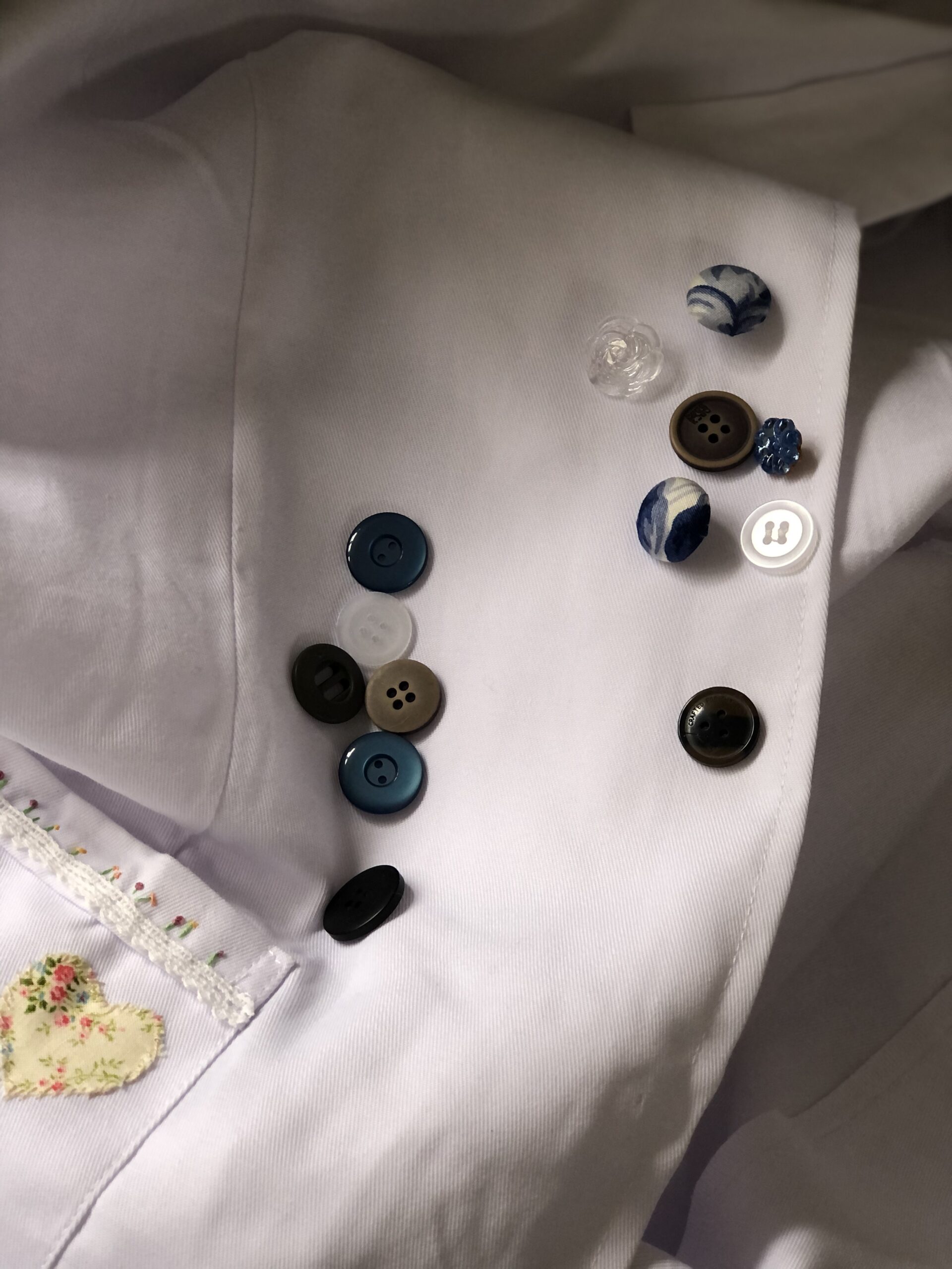 selecting buttons for bespoke art coveralls