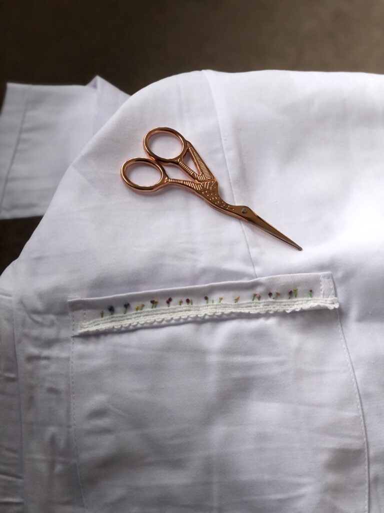 creating a custom lab coat with embroidered flowers and rose gold scissors