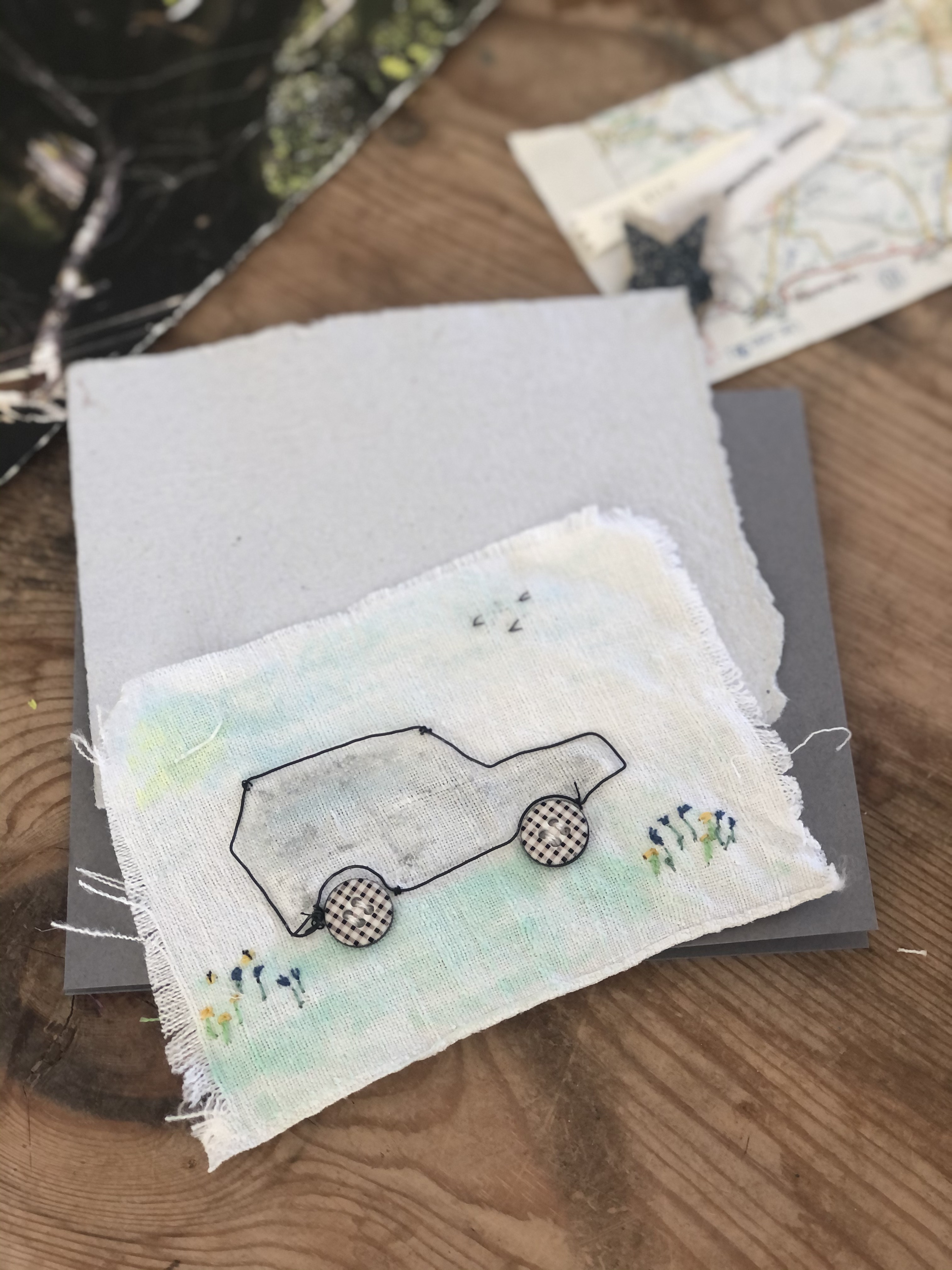 mounting a handmade birthday card of a wire car on fabric to cardstock