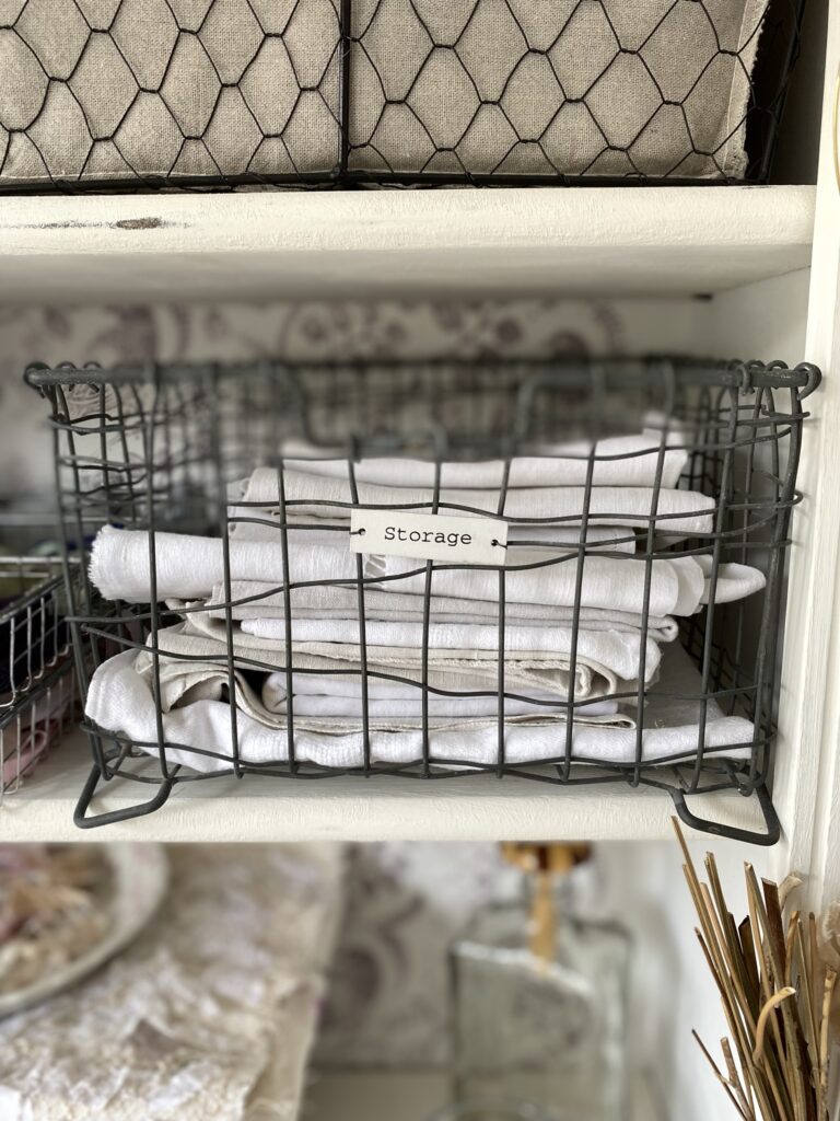 wire basket containing white linen - upcycling a bookcase