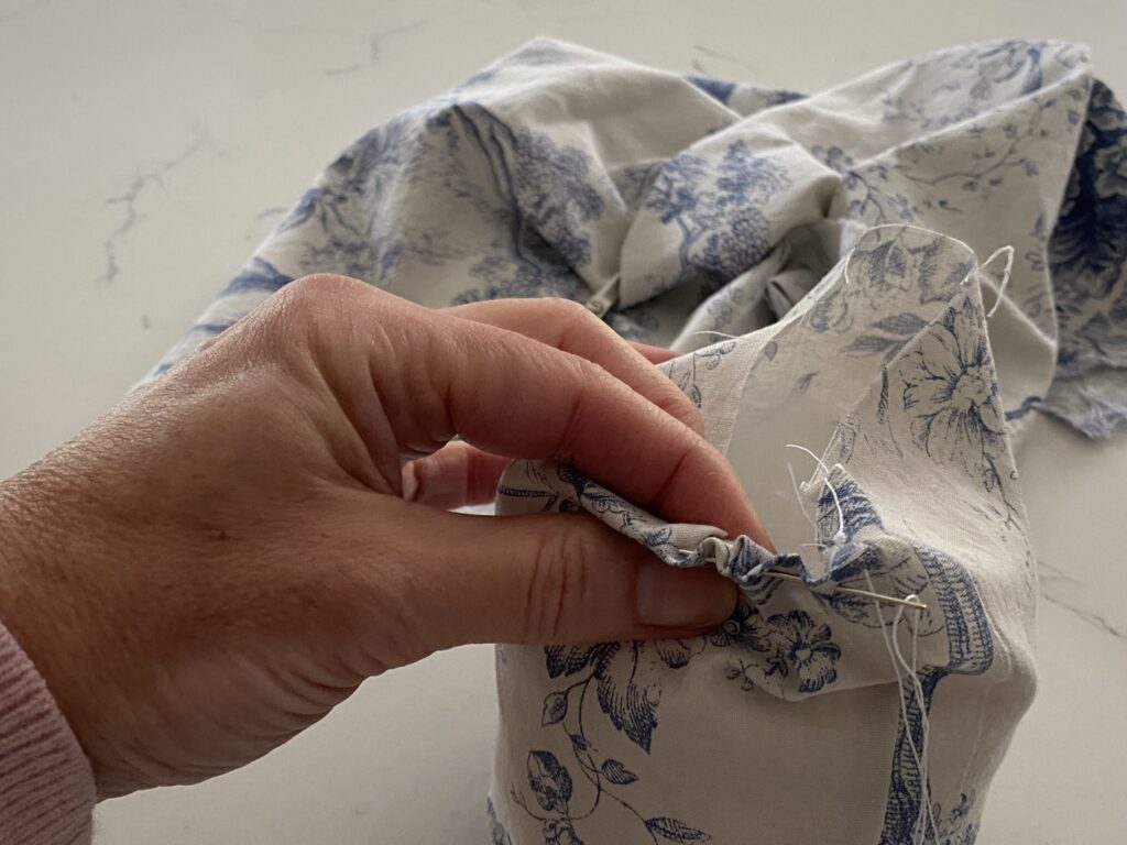 stitching a seam in blue toile fabric