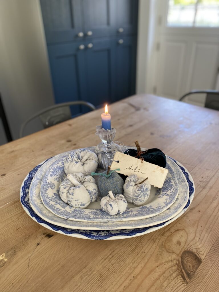 a pretty platter of blue easy fabric pumpkins and candle