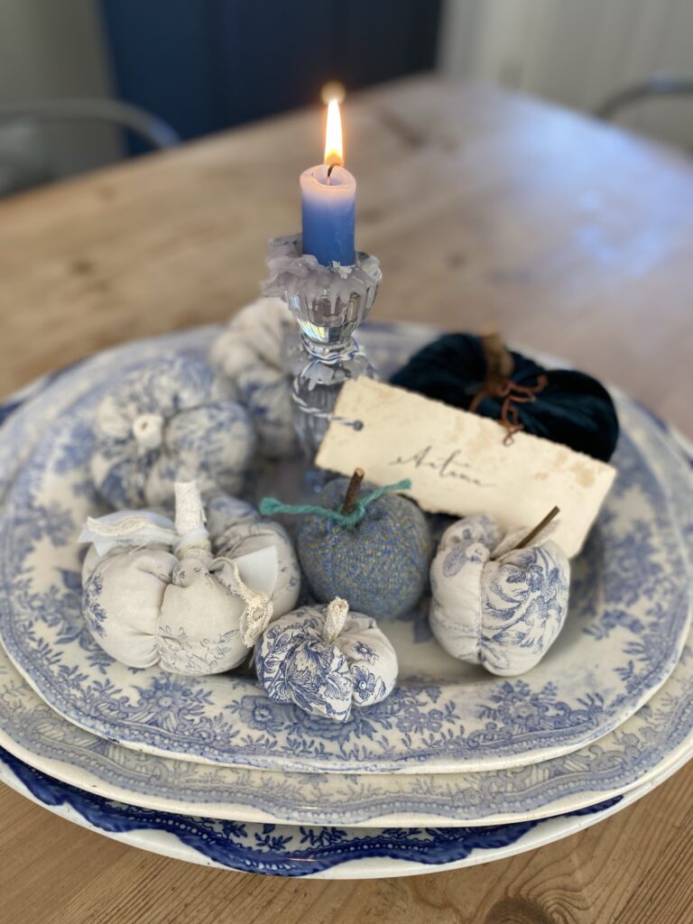 a pretty platter of blue easy fabric pumpkins and candle