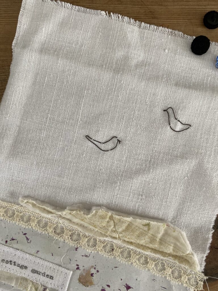 two wire birds added to white linen