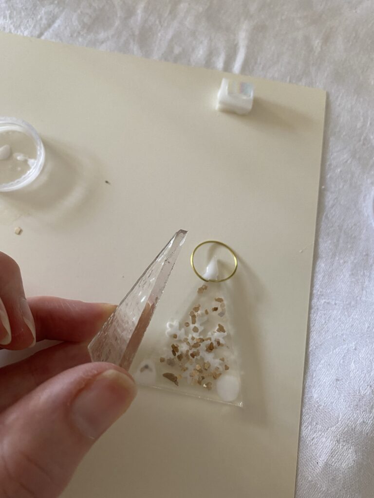 assembling pieces of glittered clear glass to make a glass christmas tree