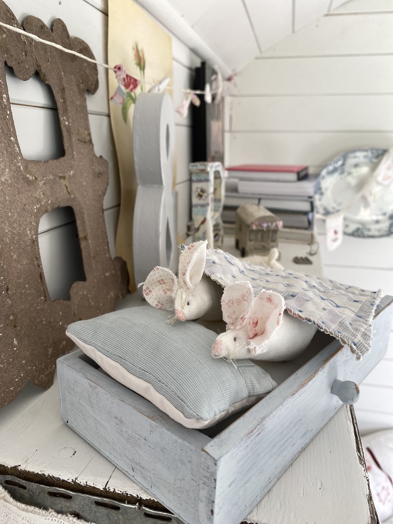 two simple diy fabric mice in homemade wooden bed on toyshelf