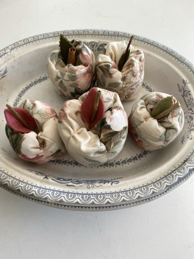 vintage bowl full of five pink and green fabric apples