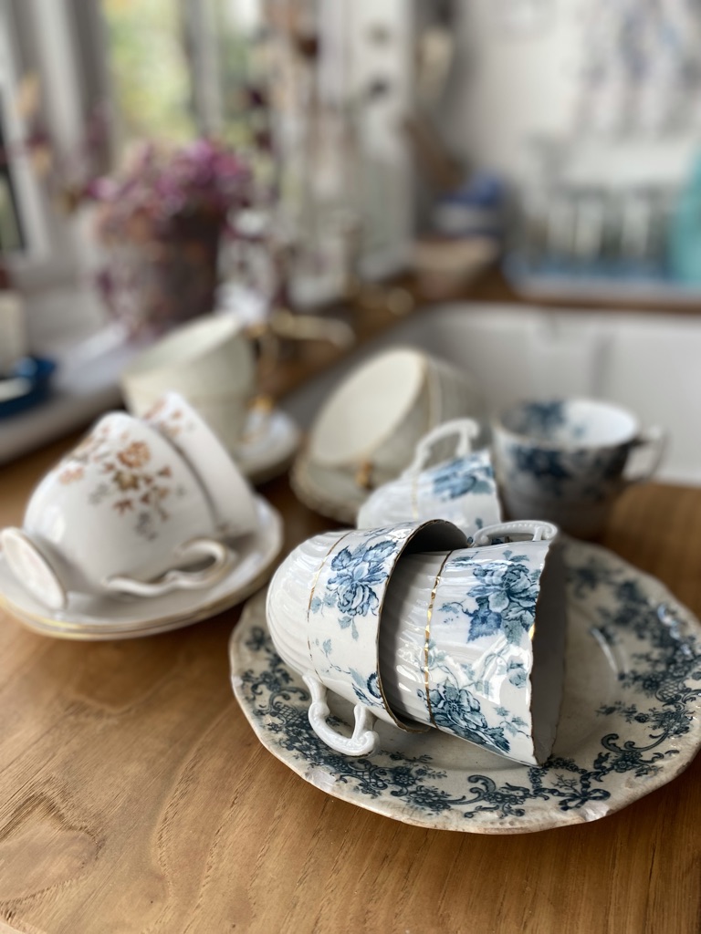 vintage tea cups and saucers on workbench