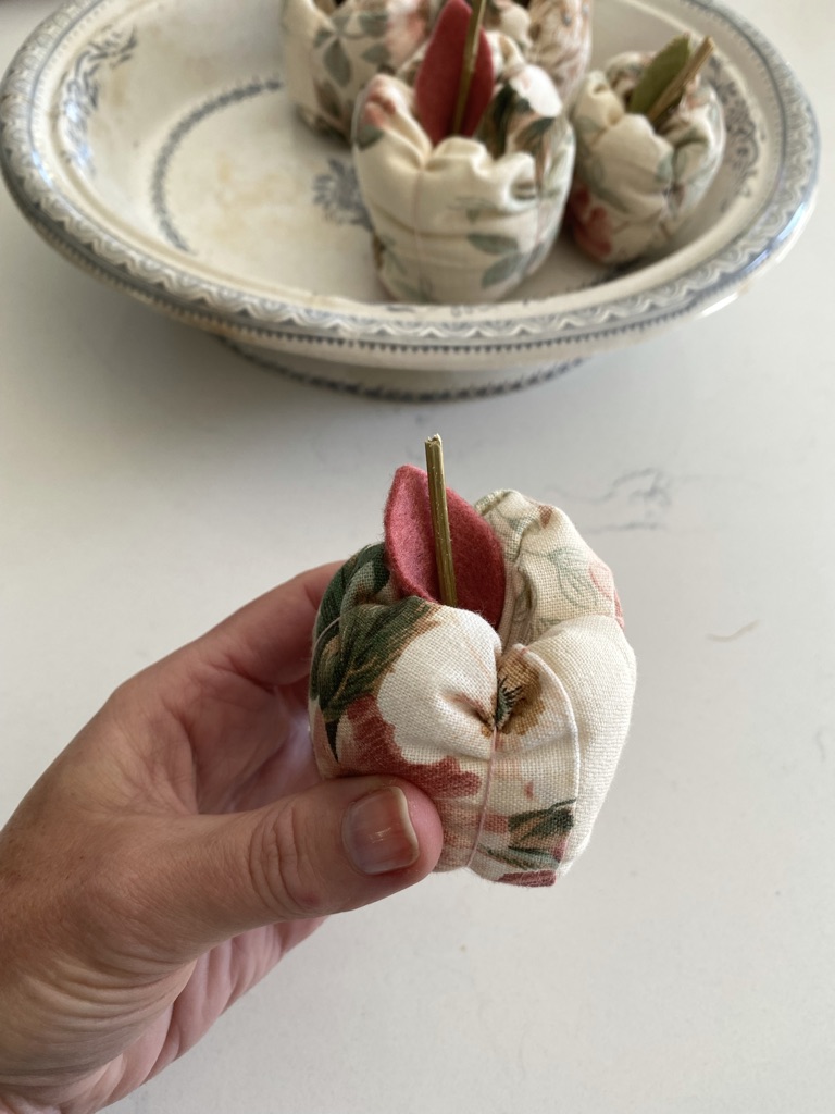 lady's hand holds fabric apple