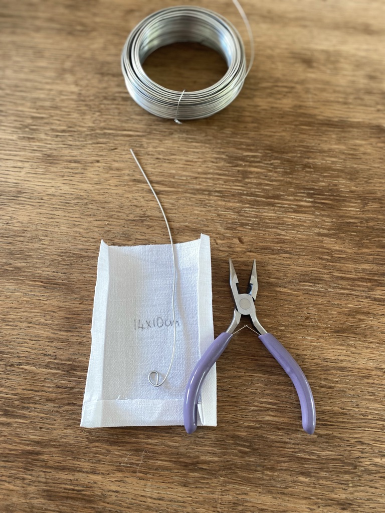 piece of white linen, off cut of wire, purple snips and a roll of wire