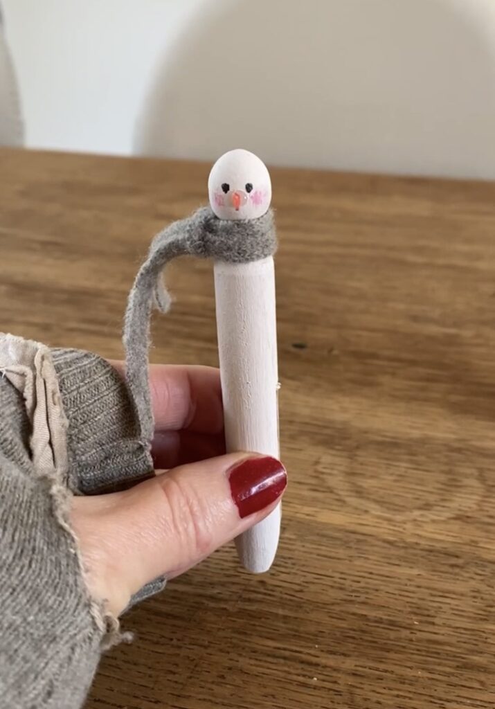 adding a fabric scarf to a dolly peg snowman