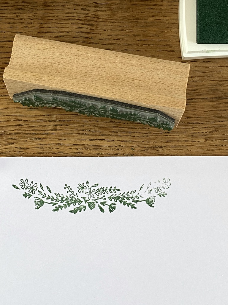 green floral design made from rubber stamp shown with green ink pad