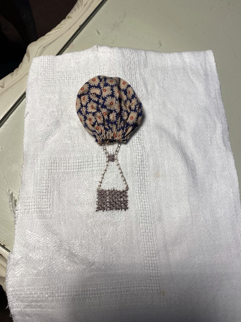 suffolk puff and embroidery begins a hot air balloon and its basket fabric collage on white linen