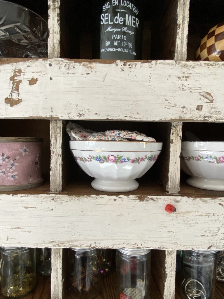 french bowls and jars in chippy white pigeon holes
