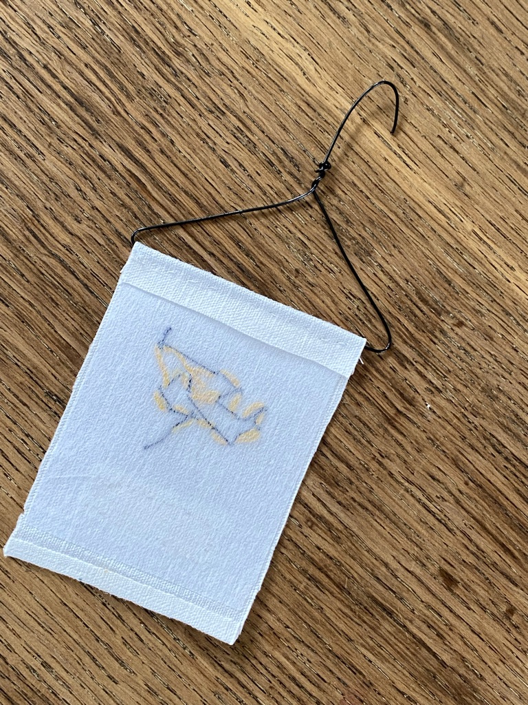 reverse of finished simple bumble bee embroidery on mini craft wire hanger