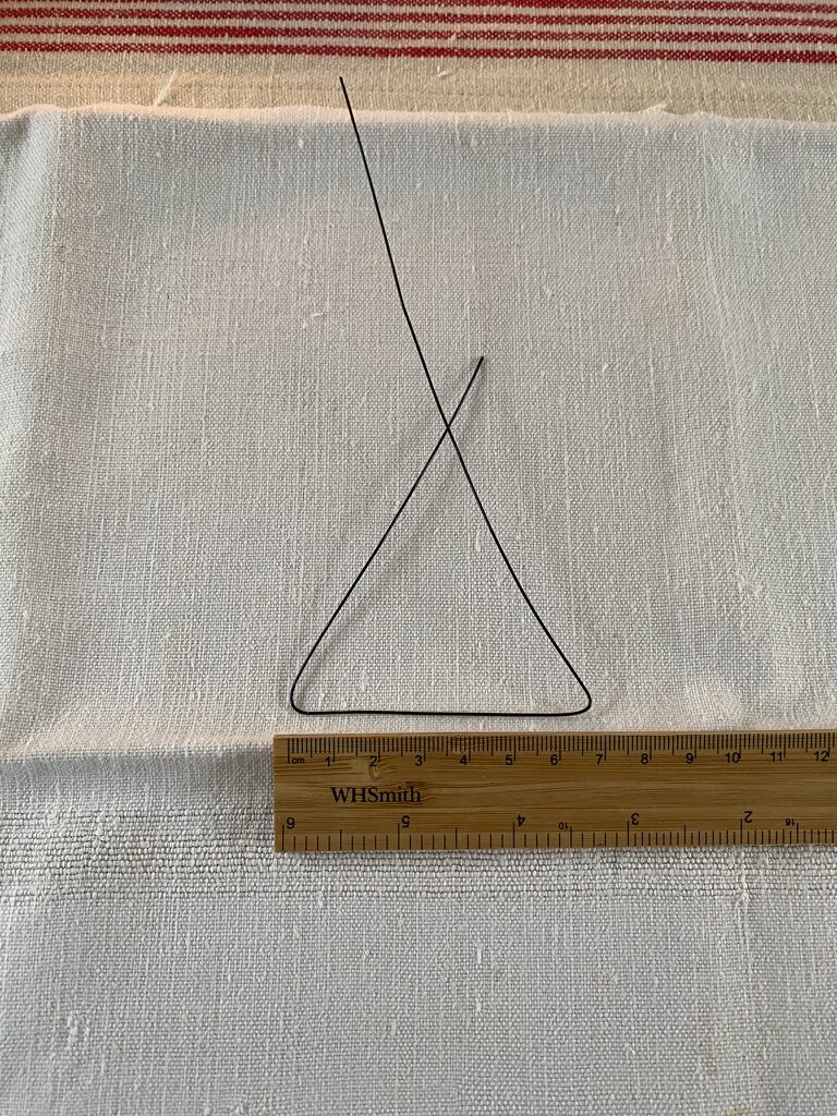 white linen, wooden ruler and bent wire